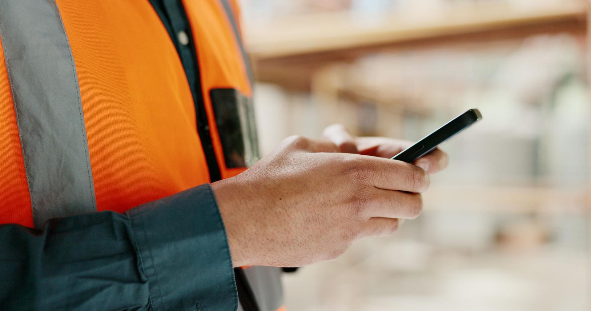 Closeup, engineer and man with a cellphone, typing and construction worker with connection, chat and website information. Hands, person and architect with a smartphone, digital app and social media